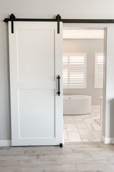 White sliding barn door to bathroom.