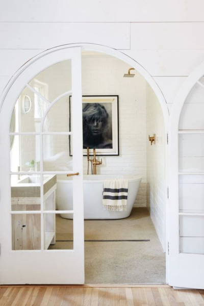 Arched French doors to bathroom.