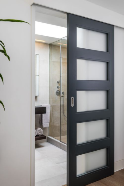 Frosted panel glass sliding door to bathroom.