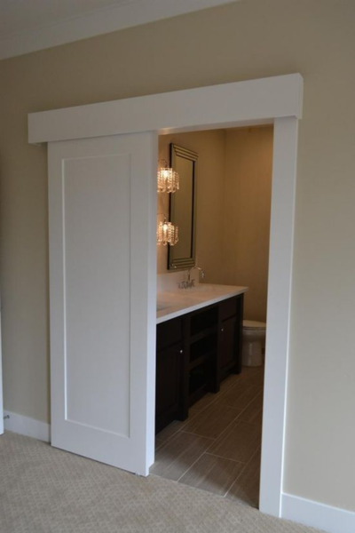 White sliding bathroom door with pelmet.